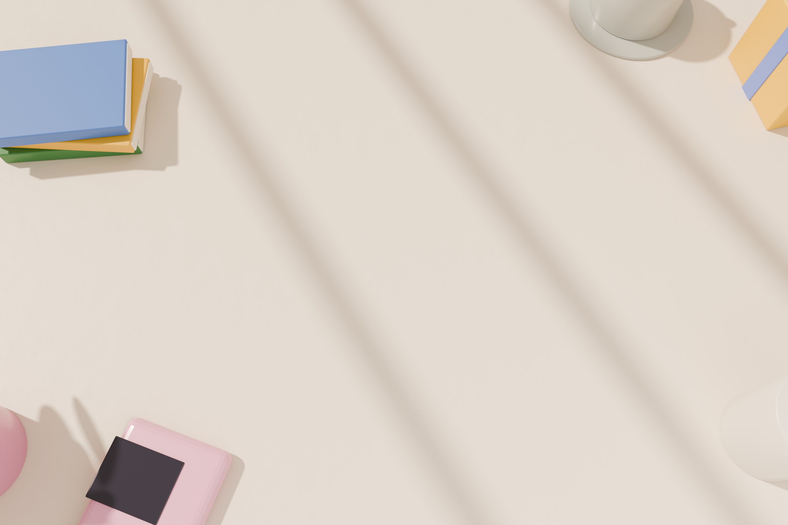 A sunny desk with books, a mug, a gift box, a pencil cup and a handheld console